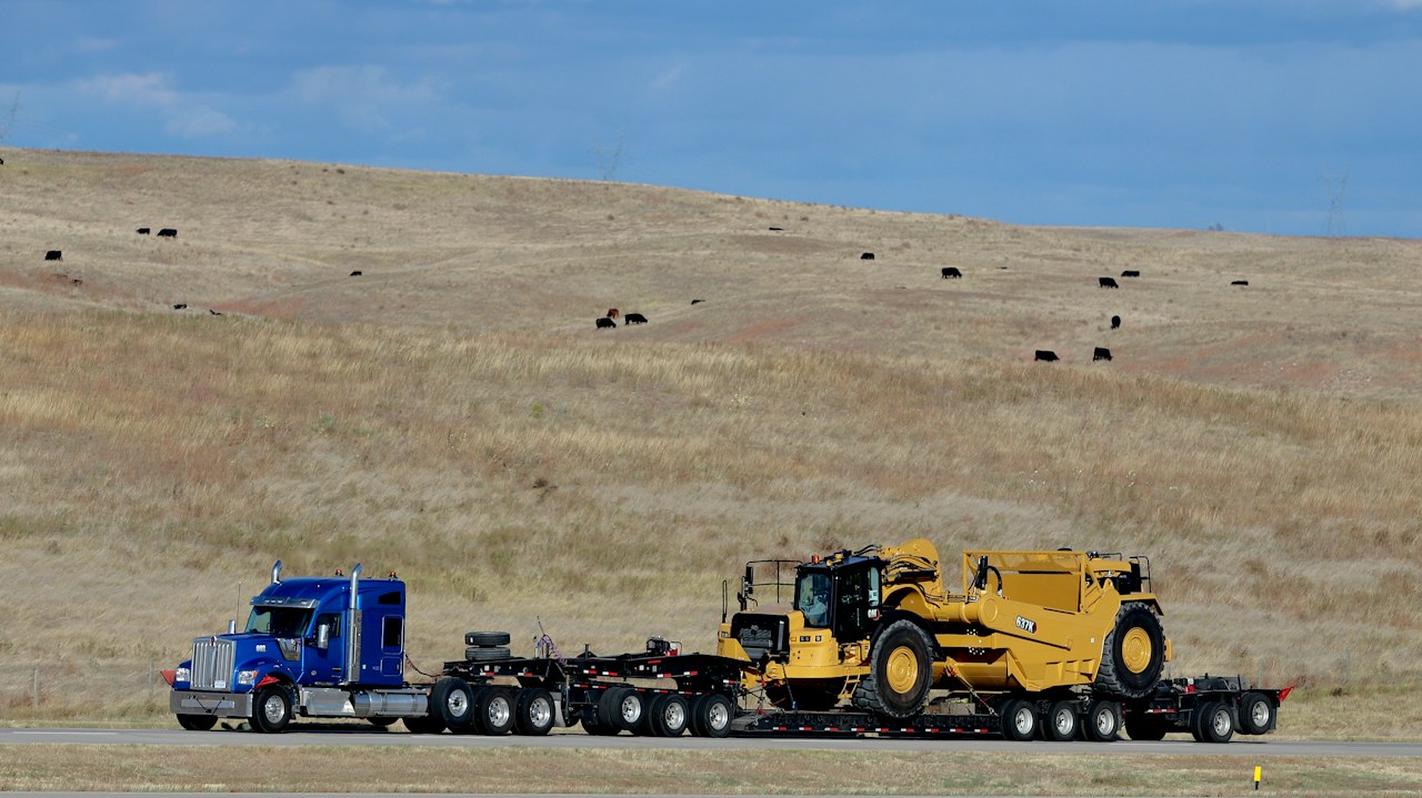 Heavy equipment on an oversized load truck, illustrative photo by Preston A Larimer