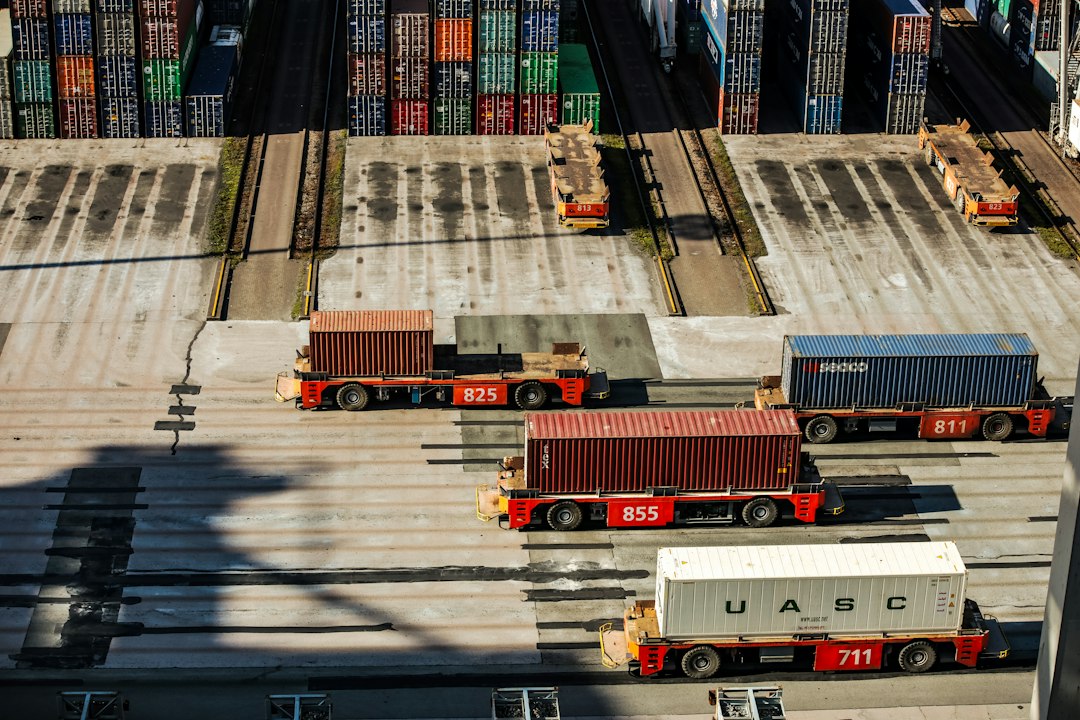 Aerial view of cargo containers and trucks at a logistics terminal